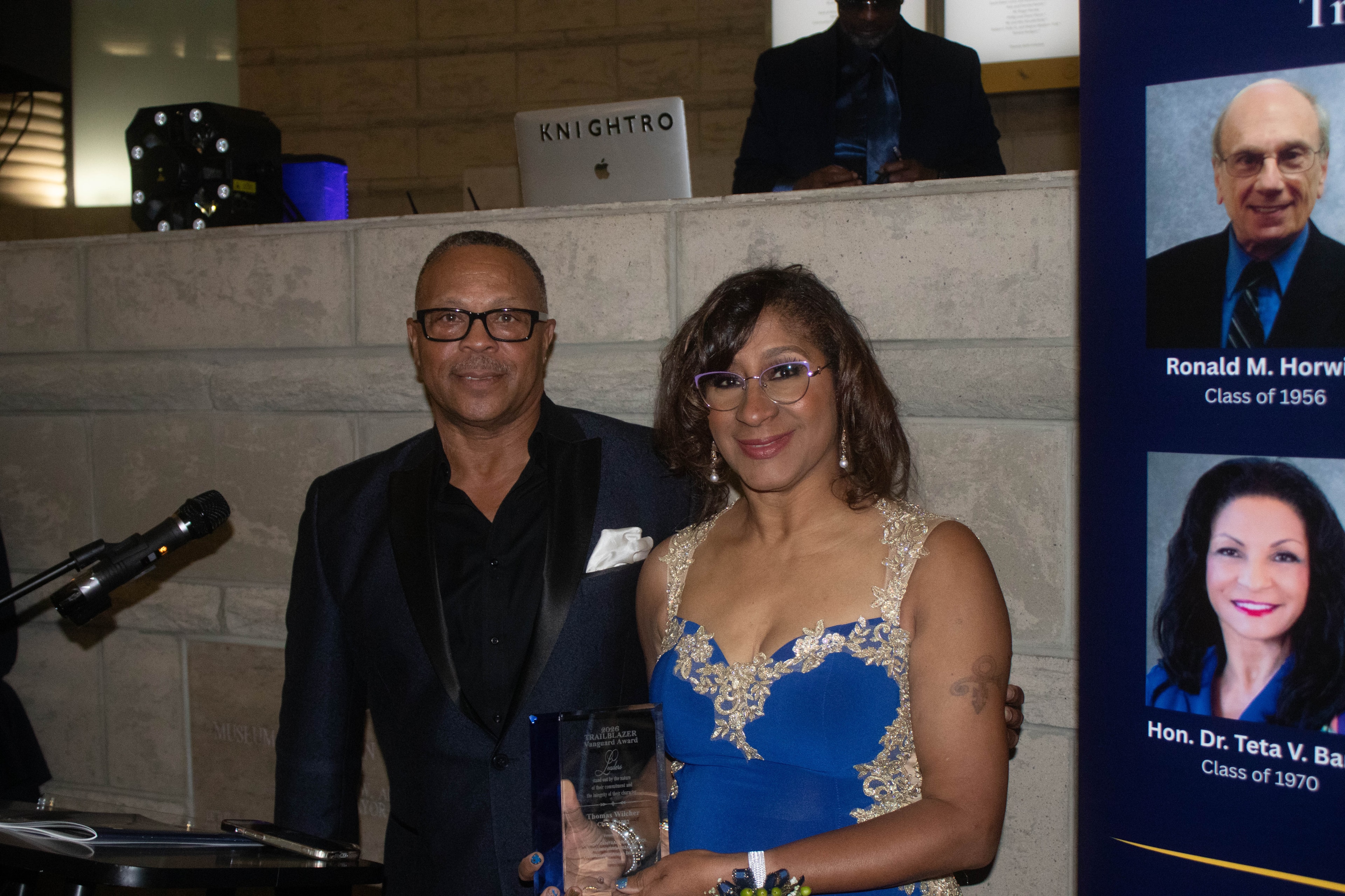 Couple at formal event holding award