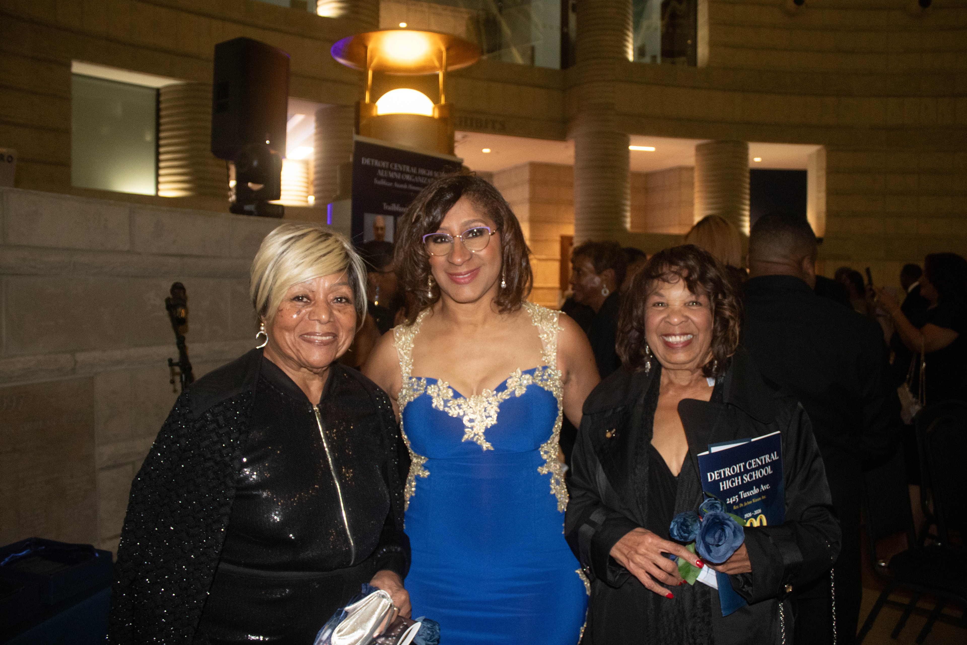 Three women posing at formal event
